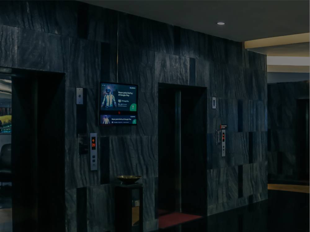 TMN screens installed beside elevators in a premium property
